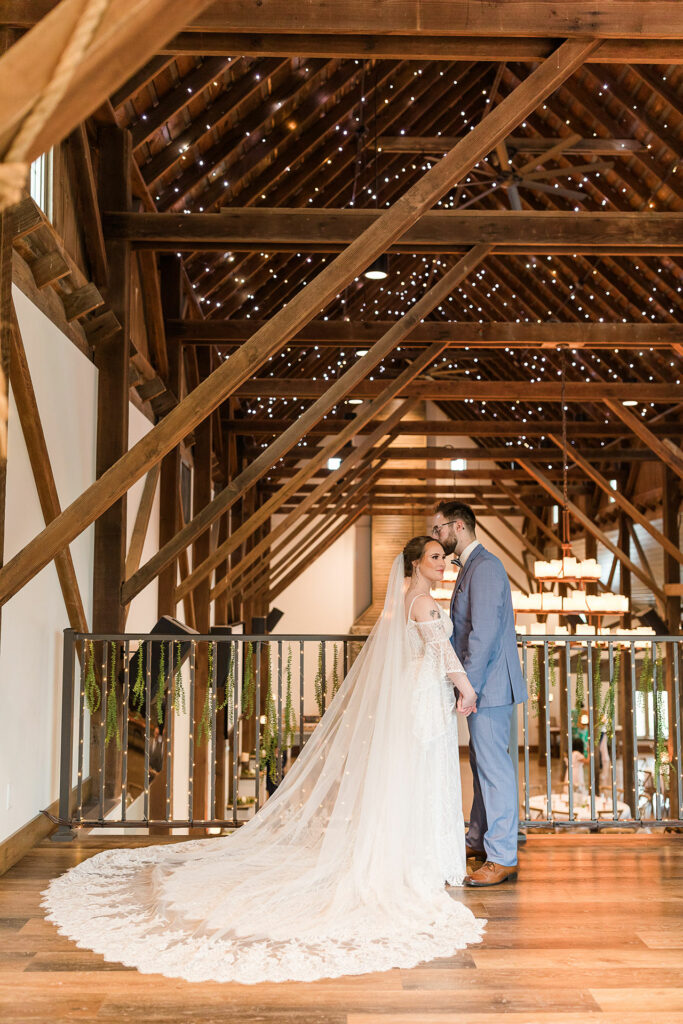 Bride and groom pose in barn loft | Emma Christine Creative