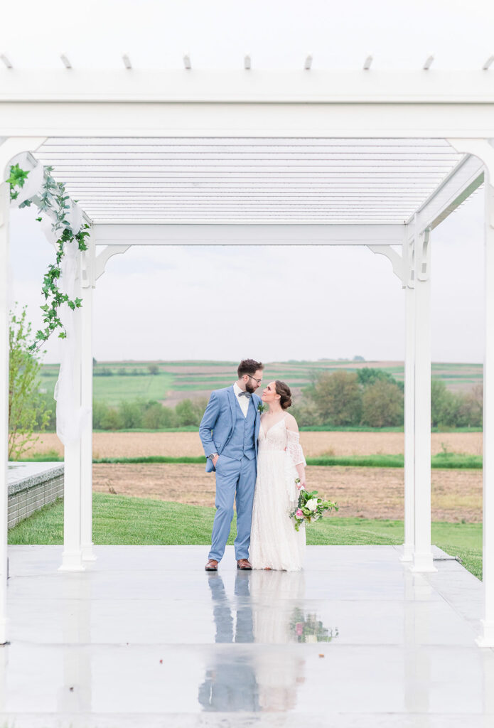 Bride and groom stand under gazebo | Emma Christine Creative